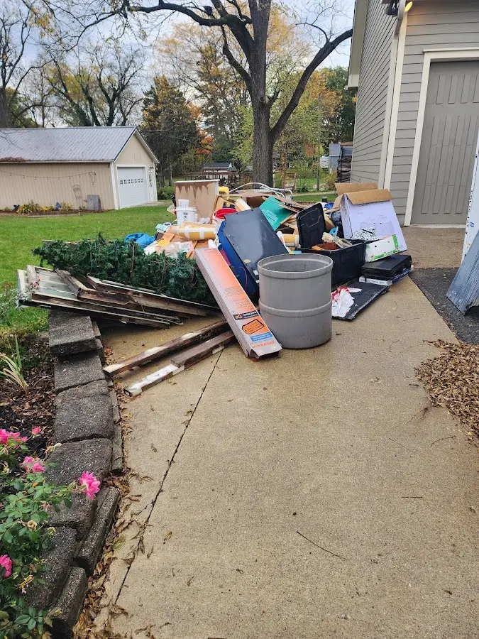 Dumpster being loaded with debris for 12 Yard Dumpster Rental in Hamden